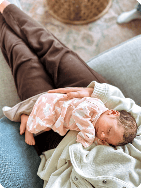 baby sleeping on mother