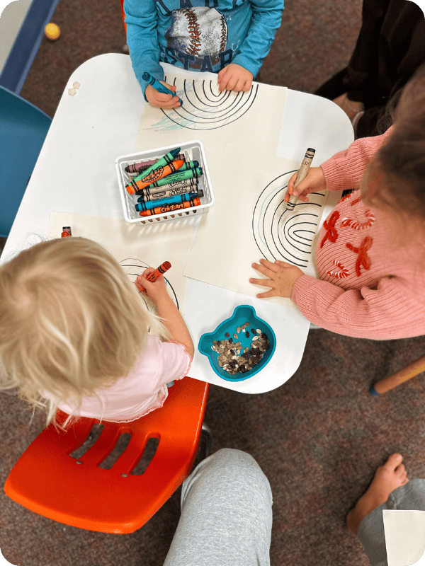 Preschoolers doing craft time at a table