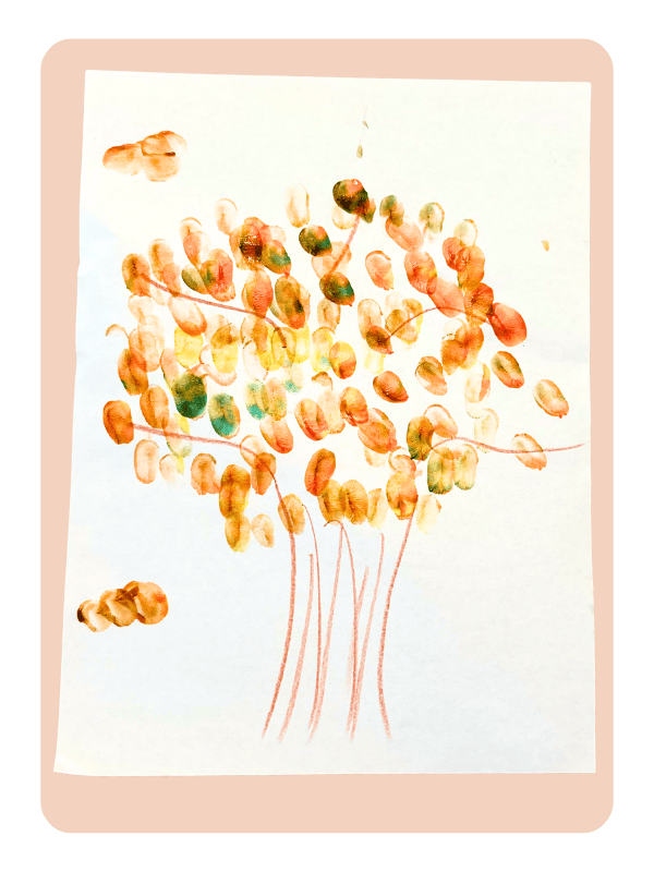 A fingerprint tree craft for kids, using paint on construction paper and fingerprints to make leaves.