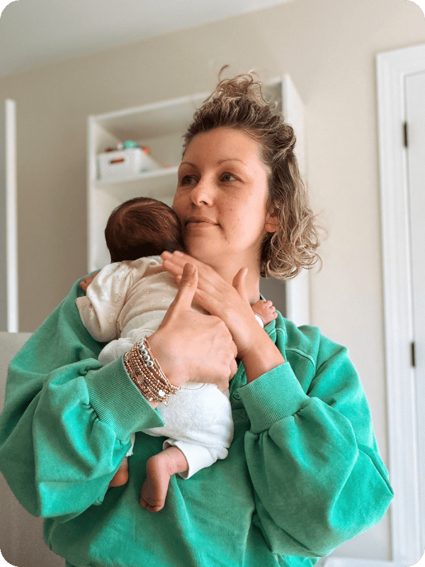 Mom burps baby on her shoulder.