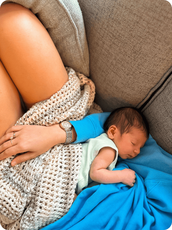 Newborn baby sleeps on mom