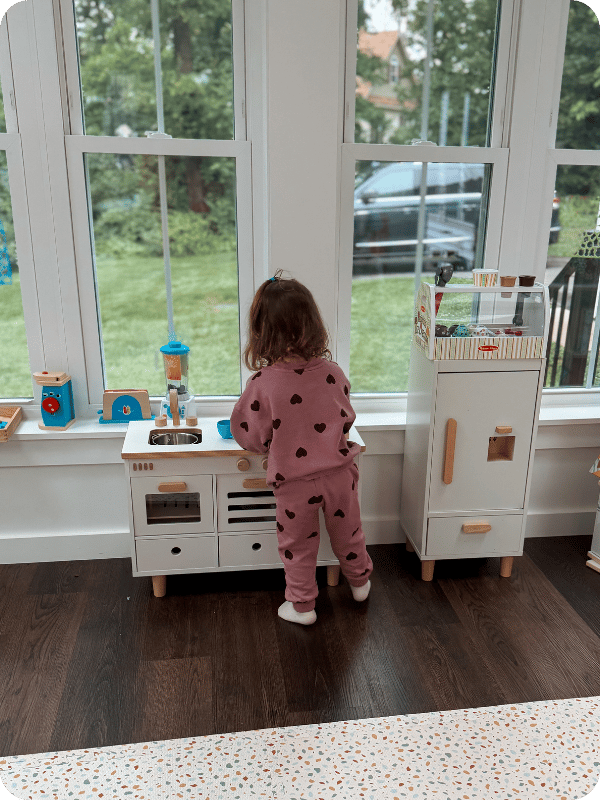 toddler playing at Lalo play kitchen