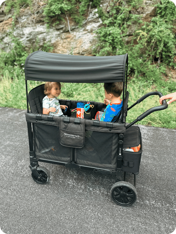 toddlers in wonder wagon travel stroller