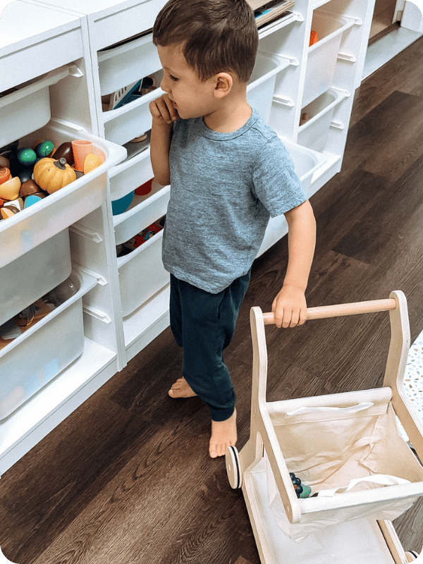 toddler using canvas kids' shopping cart during play