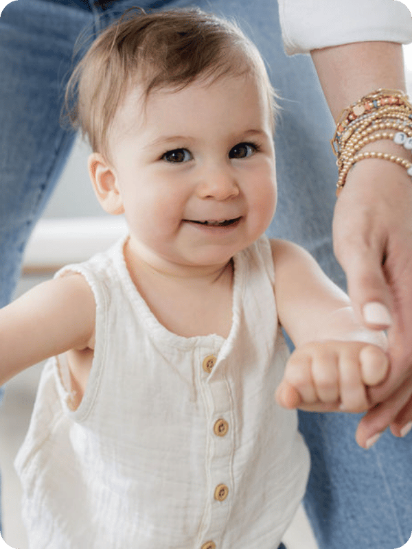 Infant smiles at the camera