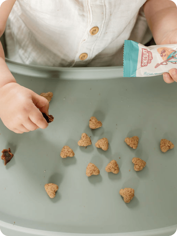 Baby self-feeds a snack with her fingers