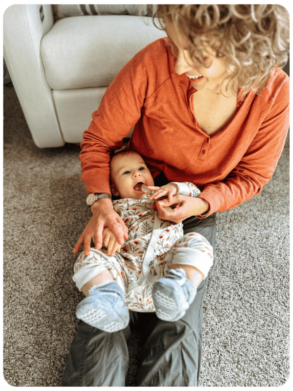 mom brushing baby's teeth