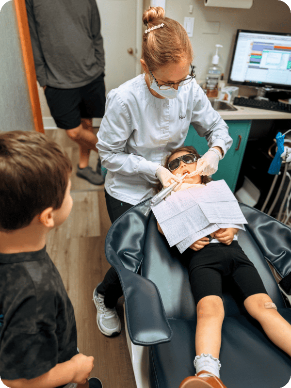toddlers at the dentist for a teeth cleaning 