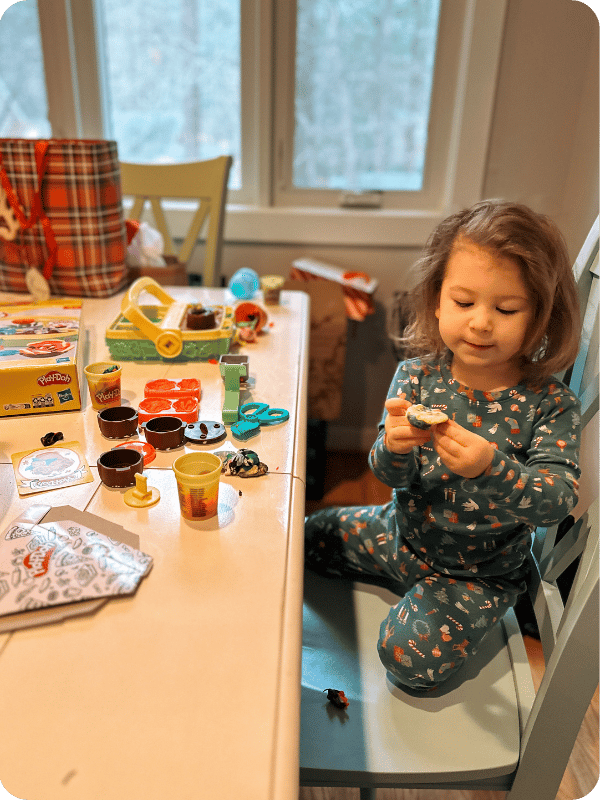 toddler playing with garden play doh set
