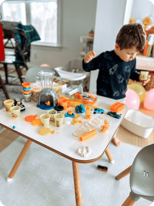 toddler playing with play doh smoothie set