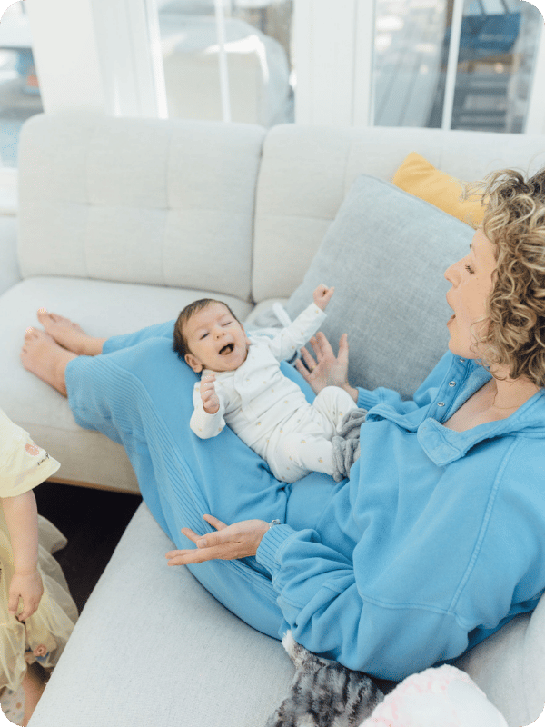 Mom and newborn have play time with gestures and mimicking sounds through early conversation.