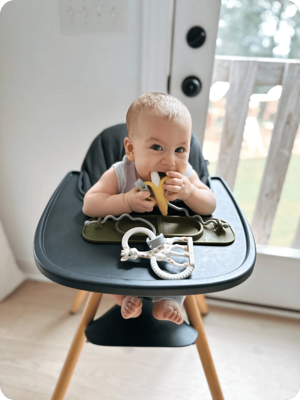 This baby is not ready to start solids. Her positioning in the high chair shows that her trunk and core muscles are not yet strong enough to maintain the proper upright seated position needed for starting solids.