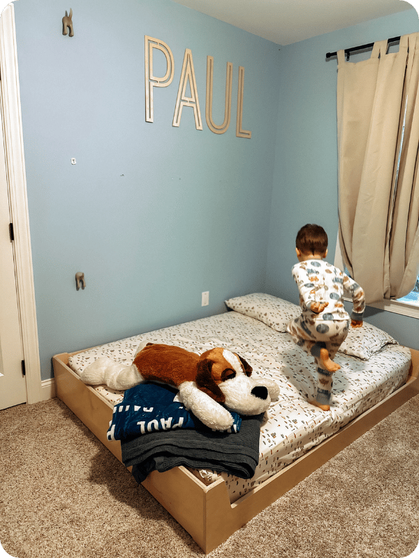 Paul excitedly jumping on his floor bed.