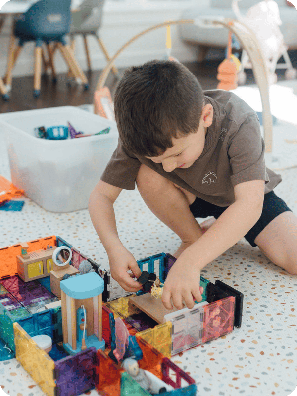 preschooler playing with Magnatiles 