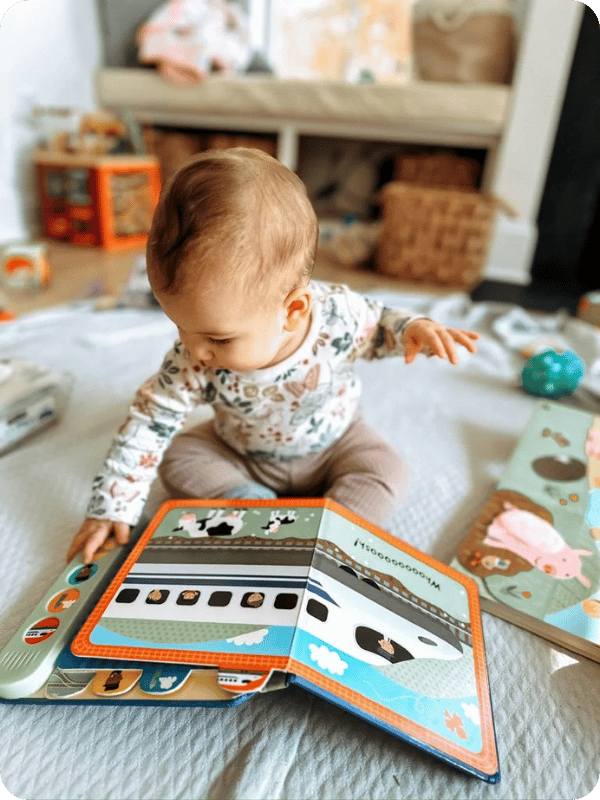 Baby looks at a book.
