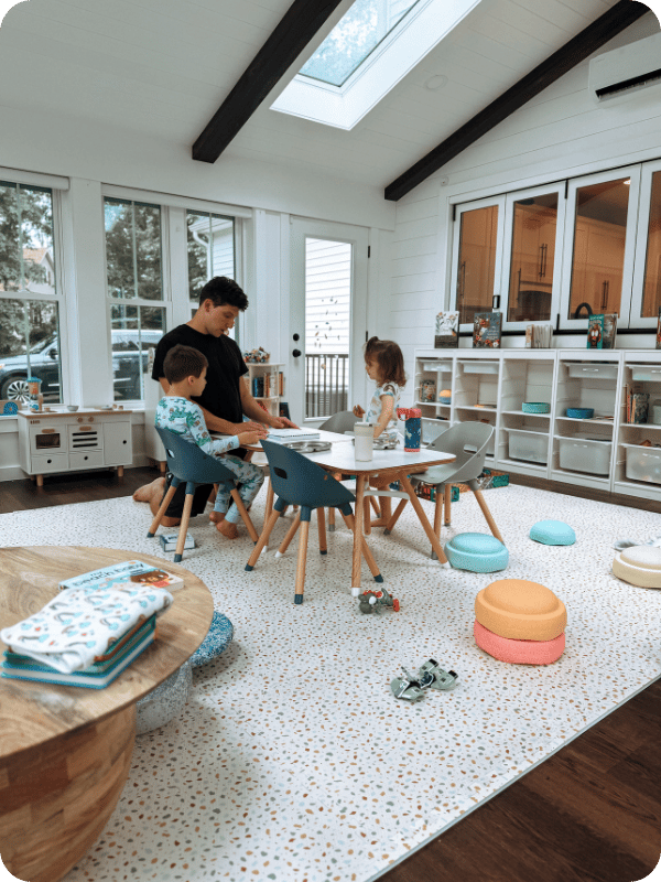 Dad helps preschooler with homeschool lessons.