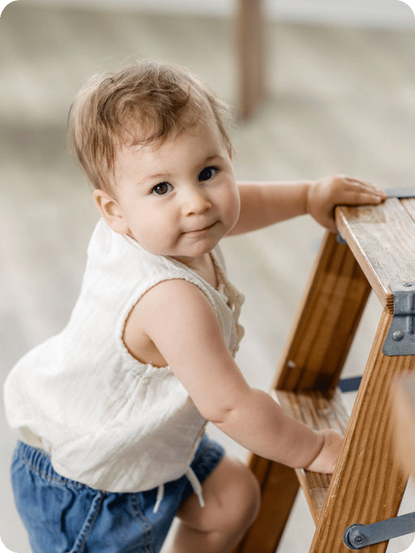 Young toddler looks at the camera and smirks