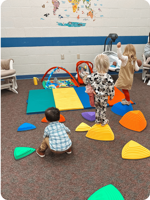 toddlers playing on stepping stones 