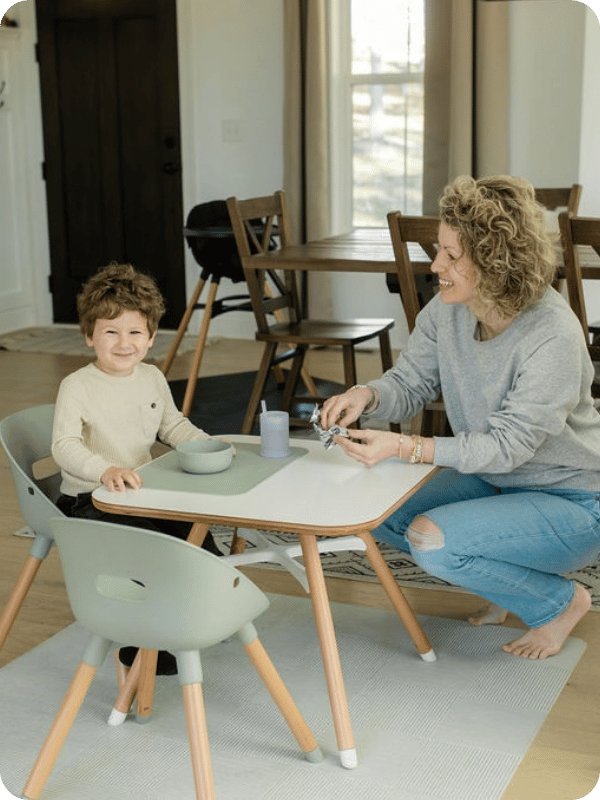 splat mat being used under a toddler table for snacks 