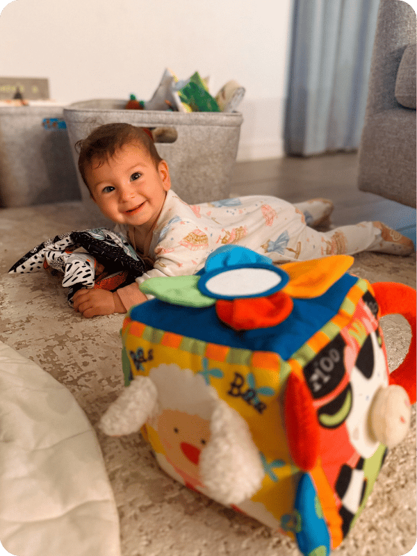 baby playing with Melissa and Doug Farmyard cube