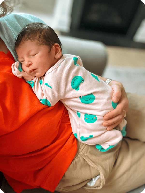 Newborn naps while mom holds her