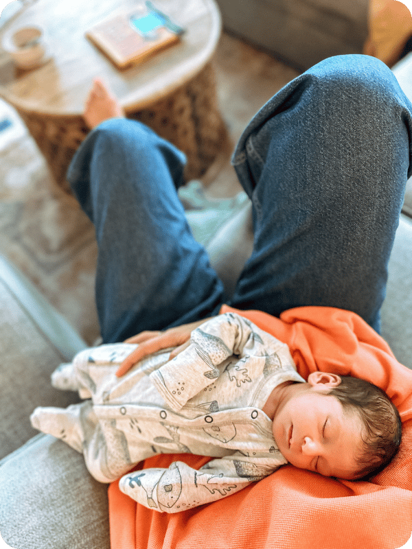 Newborn sleeps in mom's arms