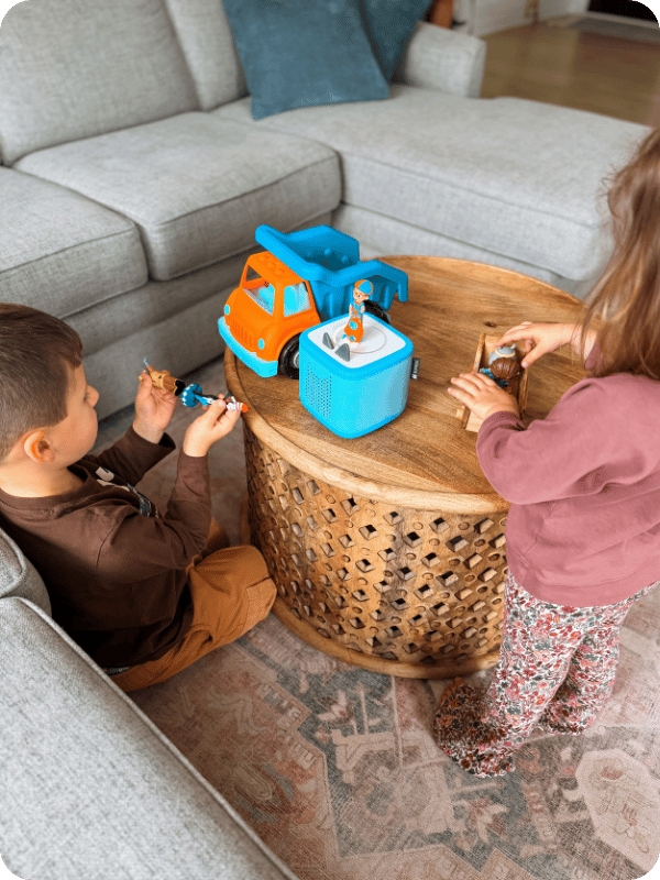 two toddlers listening to a toniebox together