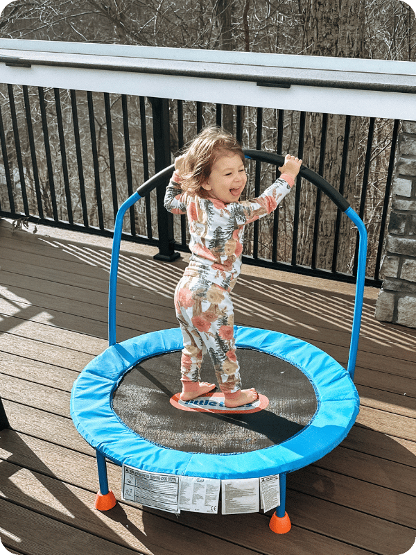 toddler jumping on little tikes trampoline